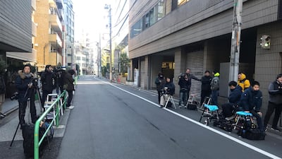 Journalists stake out at the back entrance of a building which houses an office of Junichiro Hironaka, a lawyer for Nissan’s former Chairman Carlos Ghosn, in Tokyo. AP Photo