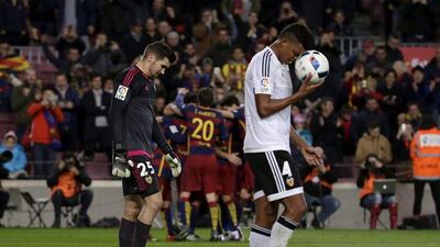Matthew Ryan, left, and Valencia defender Aderlan Santos, right, react after conceding the sixth goal. Alberto Estevez / EPA