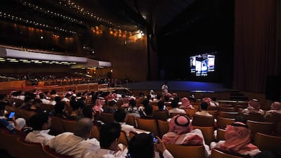 (FILES) This file photo taken on October 20, 2017 shows Saudis attending the "Short Film Competition 2" festival at King Fahad Culture Center in Riyadh. Saudi Arabia on December 11, 2017 lifted a decades-long ban on cinemas, part of a series of social reforms by the powerful crown prince that are shaking up the ultra-conservative kingdom. / AFP PHOTO / FAYEZ NURELDINE