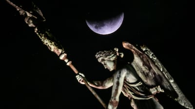 The moon next to the Quadriga statue of the Brandenburg Gate in Berlin. EPA/CLEMENS BILAN