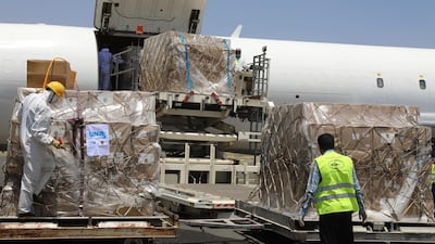 Workers unload boxes of medical supplies on arrival at Sanaa International Airport in Yemen. World Health Organization via AP