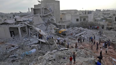 Syrians gather amid destruction in Zardana, in the mostly rebel-held northern Syrian Idlib province, in the aftermath of following air strikes in the area late on June 8, 2018. Omr Haj Kadour / AFP