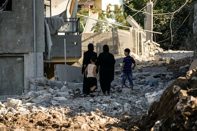 Residents inspect the damage after an Israeli military strike in Mayfadoun. AFP