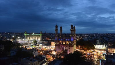 Mecca Masjid, left, and Charminar in the old market of Hyderabad. Noah Seelam / AFP