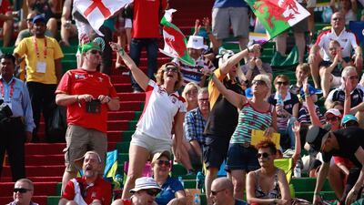 Fans of England and Wales wave their colors at the stands on Day 2 at the Dubai Rugby Sevens. Victor Besa for The National