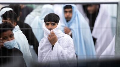 Migrants behind barriers at the Manston airfield migrant processing centre. Getty Images