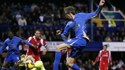 Heerenveen's goalkeeper Brian Vandenbussche, left, saves a shot from Portsmouth's England striker Peter Crouch at Fratton Park.