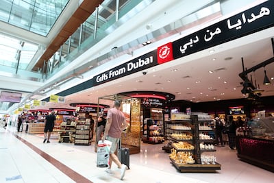 Travellers will be reminded at Dubai Duty Free shops about how long they have to get to their gate. Chris Whiteoak / The National