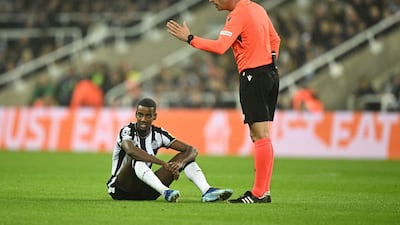 Newcastle striker Alexander Isak goes down and is forced off injured early in game. AFP