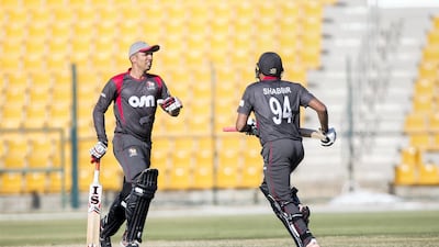 Rohan Mustafa, left, and Ghulam Shabbir run between the wickets on their way to sharing an 81-run stand during the ICC World Cricket League Championship match against Nepal at Zayed Cricket Stadium in Abu Dhabi. UAE won by seven wickets. Nezar Balout for The National
