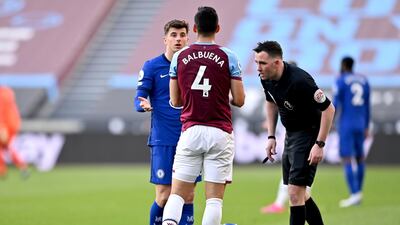 Referee Chris Kavanagh checks on Chelsea's Ben Chilwell after he is fouled by West Ham United's Fabian Balbuena. PA