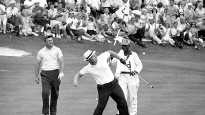 In this April 11, 1965 file photo, Jack Nicklaus prepares to toss his ball down the fairway after he putted out to win the Masters Championship at Augusta National Golf Club in Augusta, Ga. Nicklaus was tied with Gary Player and Arnold Palmer after 36 holes and wound up winning by nine shots over both of them. He set the tournament record at 271. (AP Photo/File)