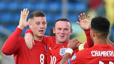England's Ross Barkley, left, celebrates after scoring a goal with teammates Wayne Rooney, centre, and Alex Oxlade-Chamberlain during their Euro 2016 qualifying match against San Marino at the Olympic stadium in Serravalle, San Marino September 5, 2015. REUTERS/Alberto Lingria