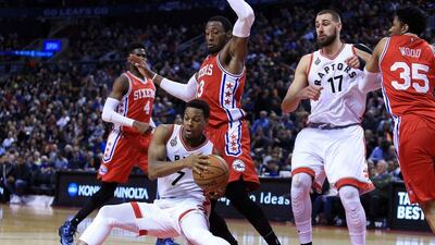 Kyle Lowry of the Toronto Raptors slips on the court as Robert Covington #33 of the Philadelphia 76ers defends during the second half of an NBA game at the Air Canada Centre on April 12, 2016 in Toronto, Ontario, Canada. (Vaughn Ridley/Getty Images/AFP)