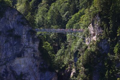Tourists stand on the Marienbruecke bridge. AP