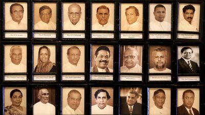 Portraits of Sri Lankan MPs including the newly appointed prime minister Mahinda Rajapaksa, centre, and sacked prime minister Ranil Wickeremesinghe, third from right in the bottom, are seen in the parliament in Colombo, Sri Lanka. AP Photo