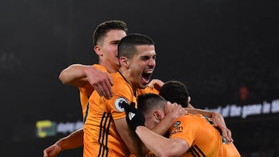 Wolves defender Matt Doherty celebrates with teammates after he scores his team's third goal. AFP