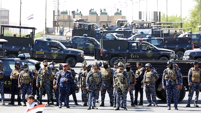 Security forces block a road as anti-government protesters try to enter the Green Zone of Baghdad. EPA