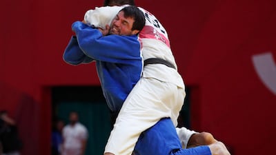 Victor Scvortov of the UAE, in blue, beat Kyrgyzstan's Bektur Rysmambetov in the bronze-medal fight at Jakarta on Thursday. Reuters