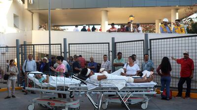 Patients rest in their hospital beds parked outside the General Hospital after they were evacuated, in Veracruz, Mexico. Felix Marquez / AP Photo