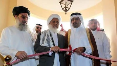Qatari assistant foreign minister Ali bin Fahad Al Hajri (second from right) and the Taliban’s Jan Mohammad Madani (centre) cut the ribbon at the official opening ceremony of the Taliban Afghanistan Political Office in Doha on June 19, 2013.