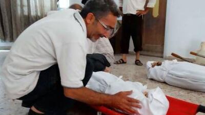 A Syrian man weeps over the body of a relative who died during last week’s gas attack outside Damascus. Tehran estimates that 100,000 Iranian soldiers and civilians were exposed to Iraqi chemical weapons, mostly mustard and nerve gases.
