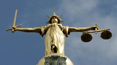 A statue on top of London's Old Bailey court. The UK's legal authorities want more court cases carried through video and telephone links Reuters