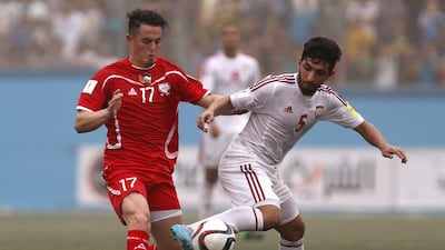 Palestine’s Pablo Bravo (L) vies for the ball with UAE midfielder Amer Abdulrahman during their 2018 World Cup qualifying match at the Faisal Al Husseini Stadium, on September 8, 2015 in the West Bank town of Al Ram. Ahmad Gharabli / AFP