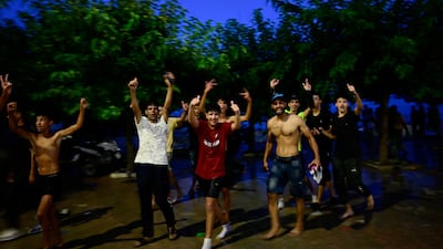 People celebrate after swimming from Moroccan territory to Ceuta. Reuters