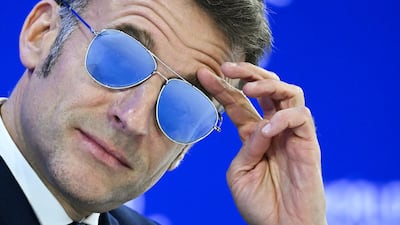French President Emmanuel Macron dons sunglasses during his address to the World Economic Forum Annual Meeting in Davos. AFP