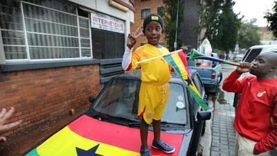A young Ghana supporters indicates the score. Photo: Bram Lammers