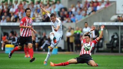 Gylfi Sigurdsson of Swansea, centre, shoots at goal during his side's loss to Southampton in the Premier League on Saturday. Stu Forster / Getty Images