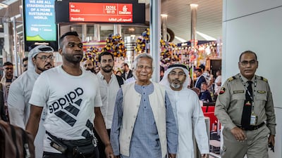 Muhammad Yunus is escorted by Emirates security personnel through Dubai International Airport before boarding his flight to Dhaka, in Dubai. AFP