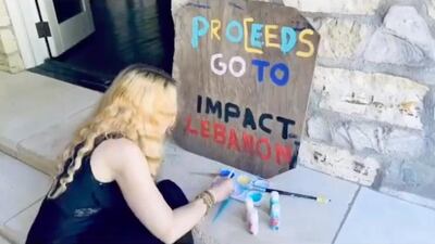 Madonna paints a sign for her family's art sale, which is raising money for Impact Lebanon. Instagram / Madonna