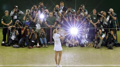 Petra Kvitova of Czech Republic kisses the winner’s trophy, the Venus Rosewater Dish, while posing for photographers after defeating Eugenie Bouchard of Canada in their women’s singles final tennis match at the Wimbledon Tennis Championships in London. Reuters