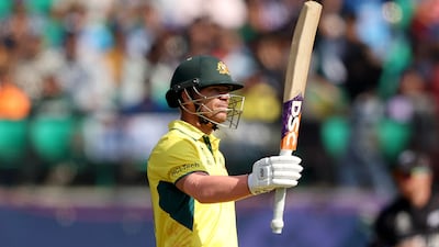 David Warner of Australia raises his bat as he celebrates after reaching half-century. Getty Images