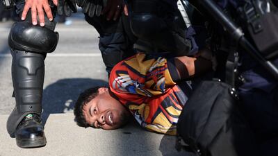A protestor is arrested. EPA