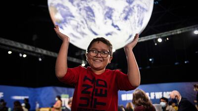 Colombian climate activist Francisco Javier Vera, 12, strikes a cheerful pose at the Cop26 summit, in Glasgow, Scotland. AFP