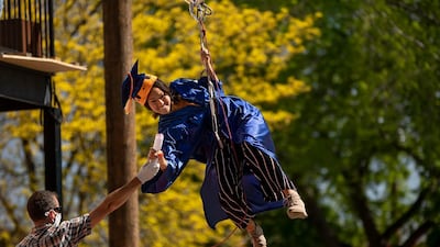 A graduate zip lines from the school to the stage where she grabs her diploma from the head administrator. Celebrating achievements is more important amid the fallout from the pandemic. AP