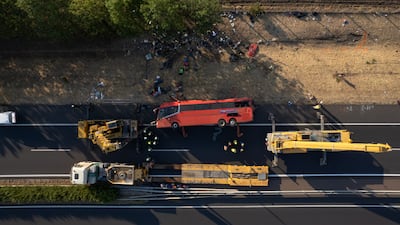 Emergency services at the scene after a tourist bus travelling from Poland ploughed into a roadside ditch in Hungary. A dozen people were killed. EPA