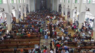 People seek refuge inside a Catholic church converted into an evacuation centre. Romeo Ranoco / Reuters