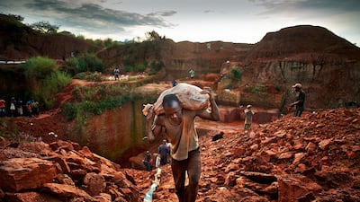 Miner carries bags filled with excess earth in 2013 to expose the diamond-rich layers near the undisclosed village in Angola. Getty