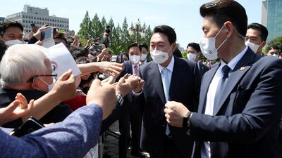 Incoming President Yoon Suk-yeol is greeted by his supporters as he arrives for his inauguration ceremony at the National Assembly in Seoul, South Korea. Reuters