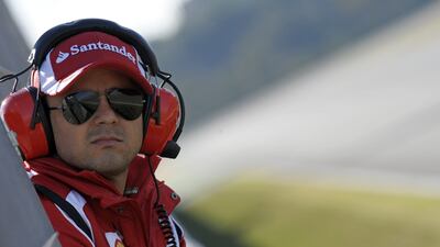 (FILES) This file picture taken on February 1, 2011 shows Ferrari team driver Brazilian Felipe Massa watching a training session at the Ricardo Tormo racetrack in Cheste, near Valencia, eastern Spain. Williams have signed Brazil's Felipe Massa as one of their drivers for the 2014 Formula One season, the British team announced on November 11, 2013. Massa, 32, joins from grid rivals Ferrari, for whom he has raced since the 2006 season, with Pastor Maldonado axed by Williams. AFP PHOTO / JAVIER SORIANO *** Local Caption *** 333020-01-08.jpg