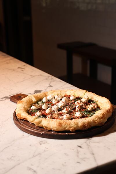 The pizza bases are flash-fried before toppings are added and finished in the oven. It makes for an extra crispy slice. Photo: Marriott Resort Palm Jumeirah