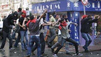 May Day protesters throw stones at riot police as they try to break through barricades to reach the city's main square in central Istanbul.