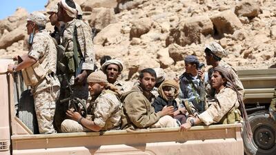 Pro-government army soldiers ride on the back of a truck in Fardhat Nahm area, which has recently been taken by the army from Houthi rebels around 60km from Yemen's capital Sanaa. Ali Owidha / Reuters