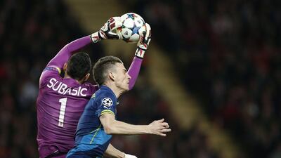 Monaco keeper Danijel Subasic makes the save over Arsenal's Laurent Koscielny during their Champions League contest on Tuesday in Monaco. Valery Hache / AFP