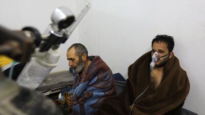 Syrians suffering from breathing difficulties following Syrian regime air strikes on the northwestern town of Saraqeb. Omar Haj Kadour / AFP
