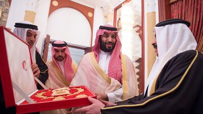 Saudi Arabia's Crown Prince Mohammed bin Salman Al Saud receives a gift from Bahraini King Hamad bin Isa Al Khalifa in Manama, Bahrain. Reuters